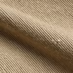 Close-up of the khaki cotton twill weave of the men's twill pants, showing the fine diagonal rib, yarn structure and fibre hairs across a soft fold