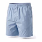 Men's boxer shorts in light blue cotton poplin, three-quarter angle showing the button fly and side vent