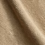 Close-up of the khaki cotton twill diagonal weave of the men's twill shorts, showing the twill lines, yarn structure and fibre hairs across a soft fold