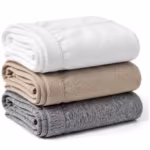 Folded stack of men's cotton briefs in white, stone and grey marl seen from behind on white, the plain back panels and folded edges showing with soft tonal elastic waistbands along the folds