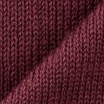 Close-up of burgundy school sweater knit showing the individual stocking stitch loops, yarn twist and fine natural fibres of the acrylic yarn