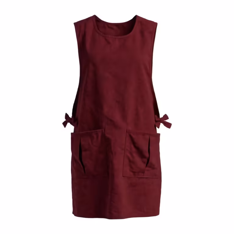 Burgundy work tabard with pockets in poly-cotton, full front view with bound scoop neck, deep armholes, two divided front patch pockets and side ties tied in bows