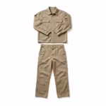Work clothes set in khaki cotton twill, long-sleeve work shirt with two flap chest pockets laid above matching flat-front work pants as one outfit, full front view