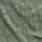 Close-up of the sage green poly-cotton plain weave of the housekeeping tunic, showing the warp and weft yarn structure and natural fibres
