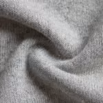 Close-up of the grey marl cotton-modal jersey knit of the maternity bump panel, showing the stitch loops and heathered yarn fibres