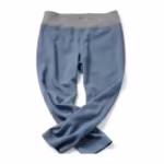 Women's maternity trousers in soft blue bengaline, flat lay view with a grey jersey waist band and the ankles crossed, showing the panel join and leg drape