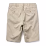Men's casual shorts in stone cotton twill, back view with plain yoke and two buttoned welt pockets