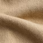 Close-up of the khaki heavy cotton twill diagonal weave of the men's work cargo shorts, showing the twill ribs, yarn structure and fibre hairs across a soft fold