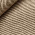 Close-up of the khaki cotton twill weave of the pants range, showing the diagonal ribs, yarn structure and fibre fly