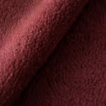 Close-up of burgundy polar fleece cloth showing the dense brushed pile and individual fibres across a soft diagonal fold