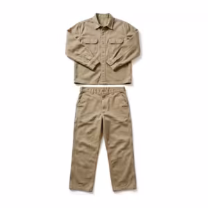 Work clothes set in khaki cotton twill, long-sleeve work shirt with two flap chest pockets laid above matching flat-front work pants as one outfit, full front view