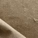 Close-up of the khaki cotton twill weave of the men's work coverall, showing the diagonal ribs, yarn structure and cotton fibres